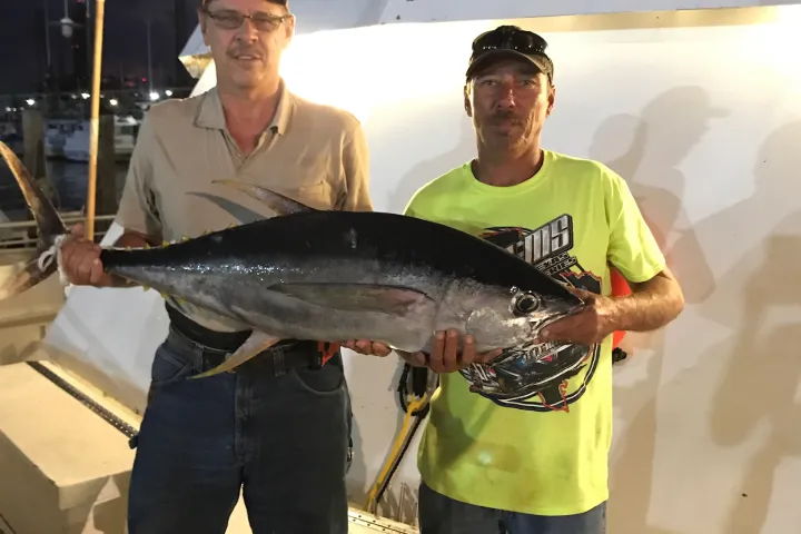 a man holding a fish