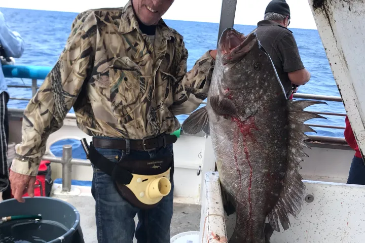 a man holding a fish
