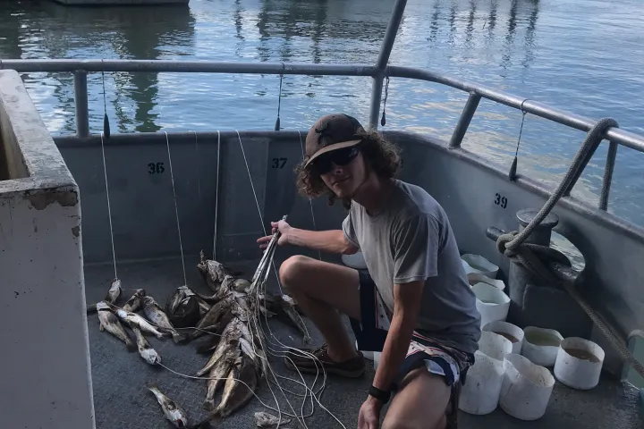 a person sitting on a boat in the water