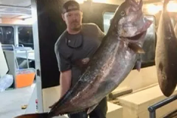 a man holding a fish