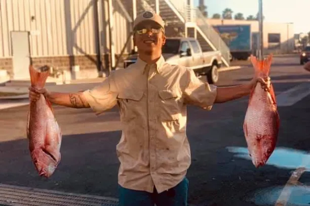 a man holding a fish