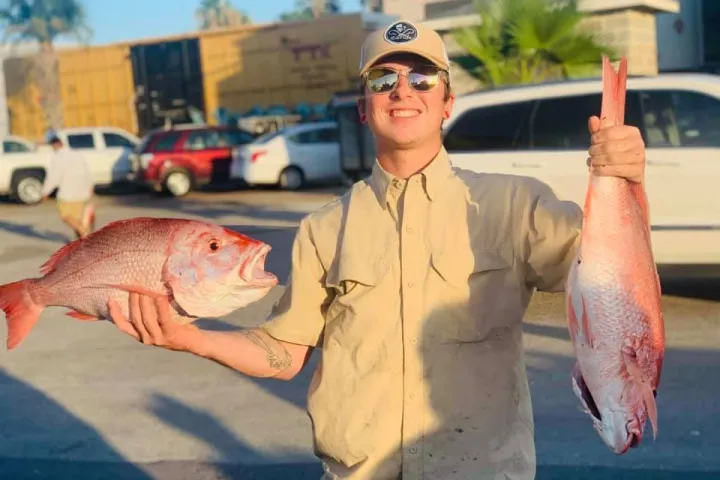 a person holding a fish