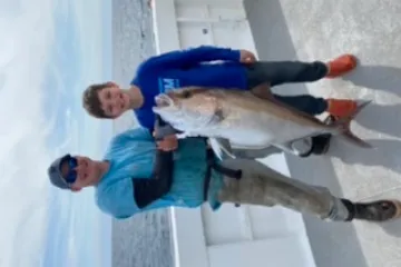 a person holding a fish