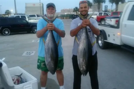 a man standing in front of a car posing for the camera