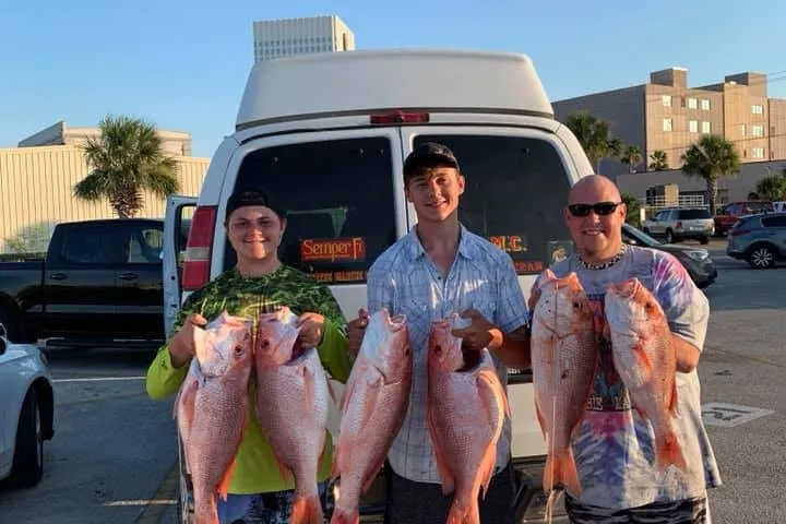 a group of people standing in a parking lot