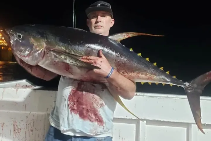 a man holding a fish