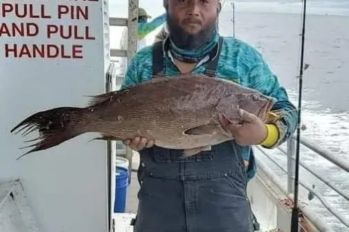 a man holding a fish